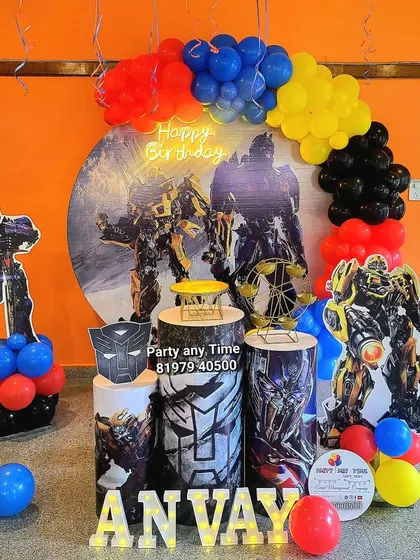 An impressive Transformers theme with character cutouts of Optimus Prime and Bumblebee, a custom backdrop, and themed plinths.