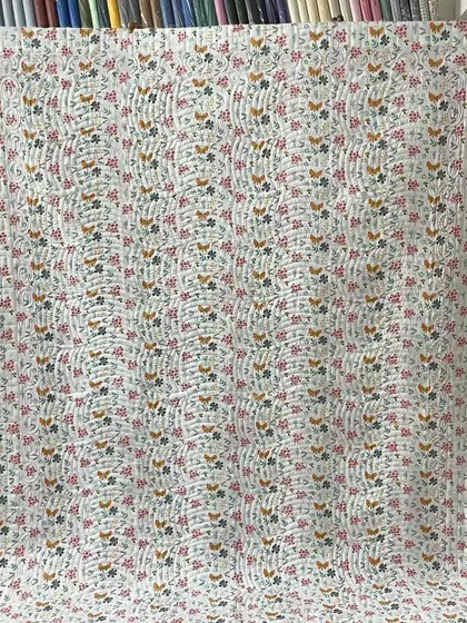 A full view of the charming backing fabric for the red and white star quilt.