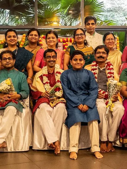 A group photo of the performers and teachers after a successful Guru Vandana. The smiles and sense of accomplishment reflect the joy of sharing our practice with the community.