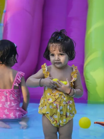 Even our littlest guests can enjoy the splash pool. This toddler is having a wonderful time in the shallow water with pool toys under the careful watch of our staff.