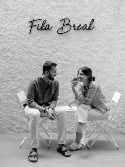 A quiet conversation over coffee, captured in a simple black and white frame. This shot has a classic, documentary feel, telling a story of everyday love.