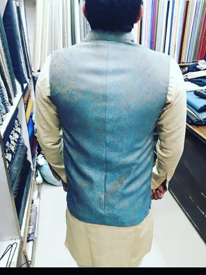 The back view of the grey textured Nehru jacket, showing the clean seam work and perfect fit across the shoulders. A good fit is important from every angle.