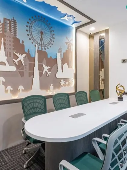 A wide-angle view of the conference room, showing how the large meeting table and chairs are positioned to maximize engagement. The themed wall art provides a unique and memorable backdrop for client and team meetings.
