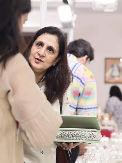 A candid moment of conversation with a client at my exhibition. I believe in building relationships and understanding the stories of the people who choose my creations for their homes.