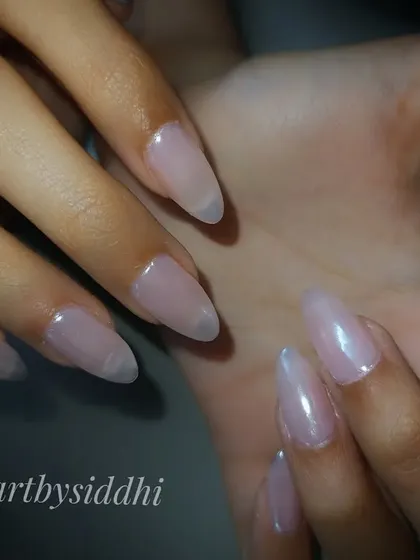 A set of ethereal "pearl" nails, which have a beautiful, iridescent finish that mimics the inside of a seashell.