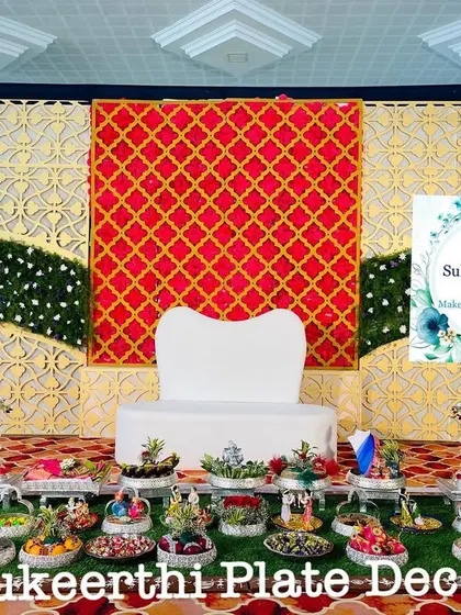 An elegant engagement plate display at Annur. The symmetry of the arrangement and the rich colours of the stage create a regal look.