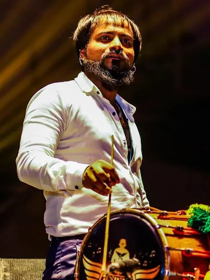 A powerful shot of our dhol player. The dhol is an iconic instrument in Punjabi music, and he plays it with an energy that electrifies the entire venue.