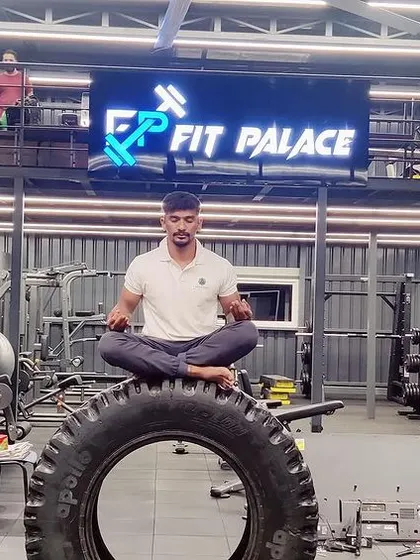 A student finding his meditative center on the gym tire at Fit Palace, a perfect example of our mind-body approach.