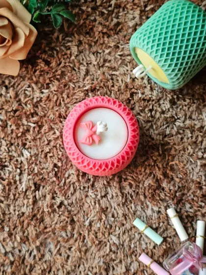 An overhead view of the pink Mesh Pattern candle. This design is modern yet sweet, making it a versatile gift or a lovely piece of personal indulgence.