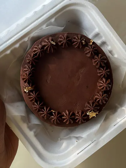 Our bento cakes are perfect for smaller, intimate celebrations. This one features a rich chocolate ganache with delicate piping and gold leaf details.