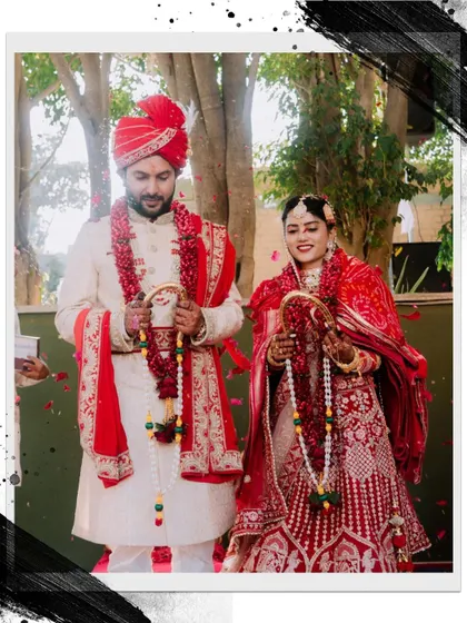 A stylized portrait of the couple during their 'Varmala' ceremony.