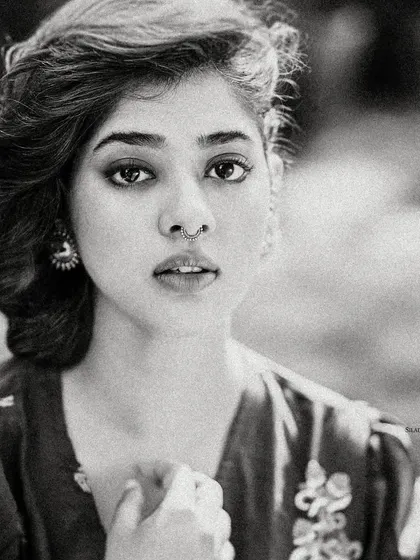 A grainy, black and white version of Ditipriya Roy's portrait. This artistic choice gives the image a timeless, film-like quality and emphasizes her expressive features.
