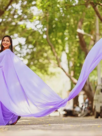 This shot captures the full length of the lavender saree's trail as it sweeps across the ground.