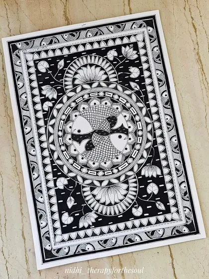 A slightly angled view of the Madhubani fish artwork, highlighting the texture of the paper and the richness of the black ink.
