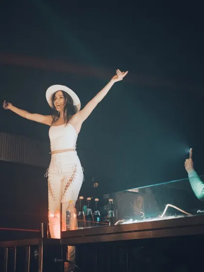 Arms open wide, embracing the energy of the crowd at J Club. It's a feeling of pure joy.