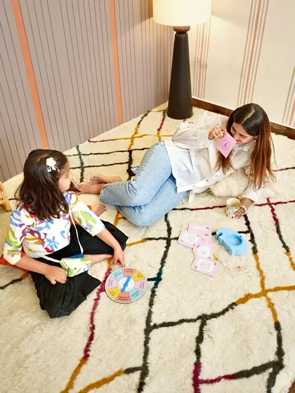 Playing a game with my daughter on our handcrafted rug. These moments of floor play are where we build our connection and make memories.