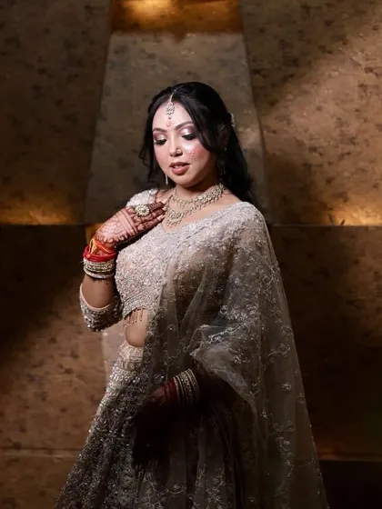 A pensive and elegant pose, with the bride's eyes closed to showcase the beautiful eye makeup.