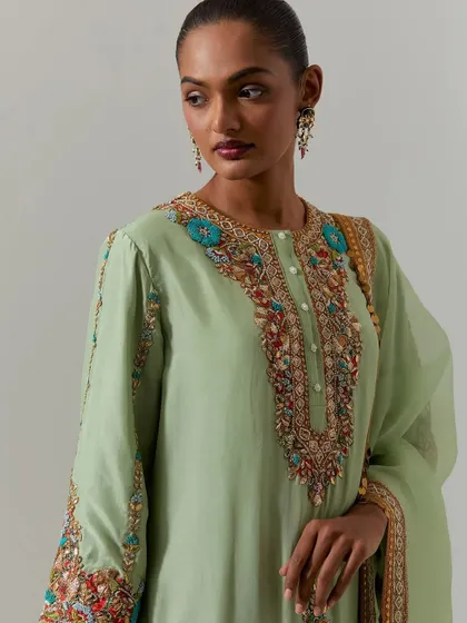 This pistachio green kurta features a stunning, multi-colored embroidered yoke. It's a beautiful example of how vibrant threadwork can transform a simple silhouette.
