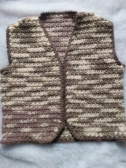 A flat-lay of the Lisa Vest, highlighting the textured stitch and clean V-neckline.