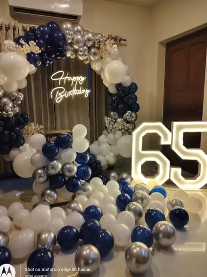 A full view of the 65th birthday decor, showing how it transforms a simple room into a stylish party space.