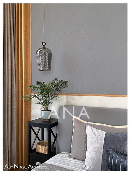 A detail of the master bedroom's bedside, featuring a ceiling-hung pendant light. This design choice keeps the nightstand clear and adds a touch of modern elegance to the room.