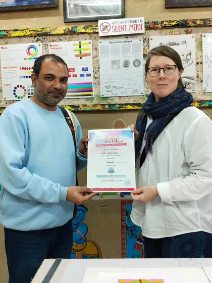 Our founder, Mohit Manocha, presenting a certificate to an international student at our Rangoli Making Workshop. We welcome artists from all over the world.