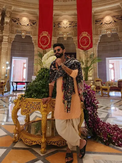 Channeling royal vibes at the Umaid Bhawan Palace. A classic dhoti-kurta set with a statement shawl for a majestic wedding event.