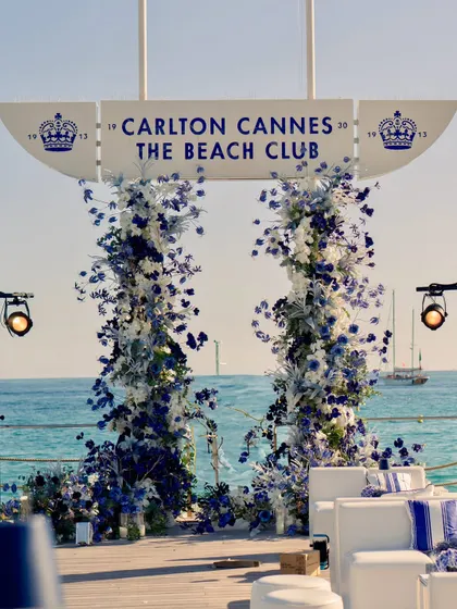 The floral arch glowing in the evening light, with spotlights ready to illuminate the structure as night falls.