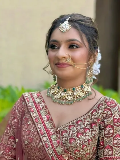 A close-up of the bridal makeup, detailing the soft eyeshadow blend, neat eyeliner, and the perfect shade of lipstick to complete the look.
