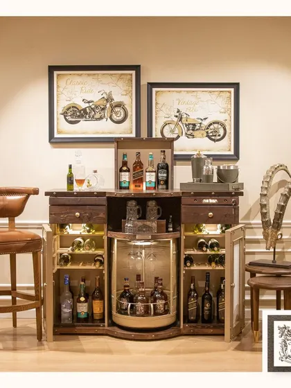 This room is curated for the enthusiast, featuring vintage motorcycle prints above a stunning automated bar cabinet. It's a perfect blend of classic machinery and modern luxury.