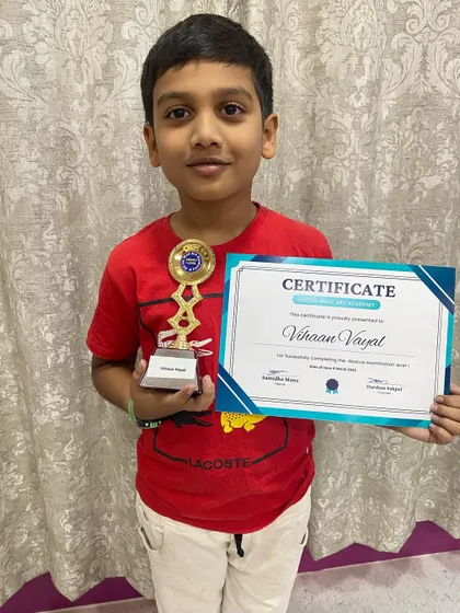 Vihaan Vayat proudly holds his certificate and trophy from our Abacus prize distribution event.