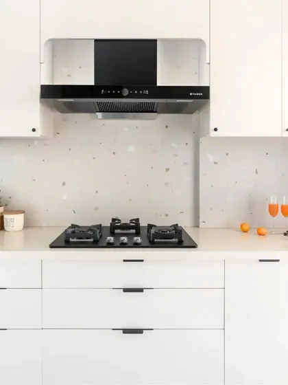 This compact kitchen design is a masterclass in optimizing a small footprint. I used white laminates to enhance the sense of space, a terrazzo tile backsplash for personality, and black hardware for a cohesive finish.