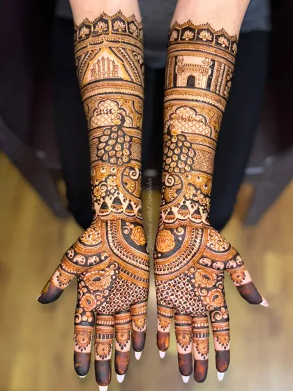 A tribute to the couple's heritage, this bridal design features Jaipur's Hawa Mahal on one arm and Hyderabad's Charminar on the other. Your love story, illustrated with intricate henna details.