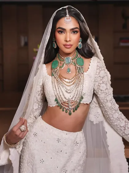 The full look. A modern bride in a stunning white lehenga, with makeup that is both elegant and timeless.