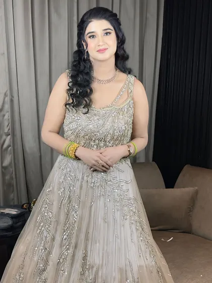A full-length photo of the client, looking elegant and ready for her engagement party.