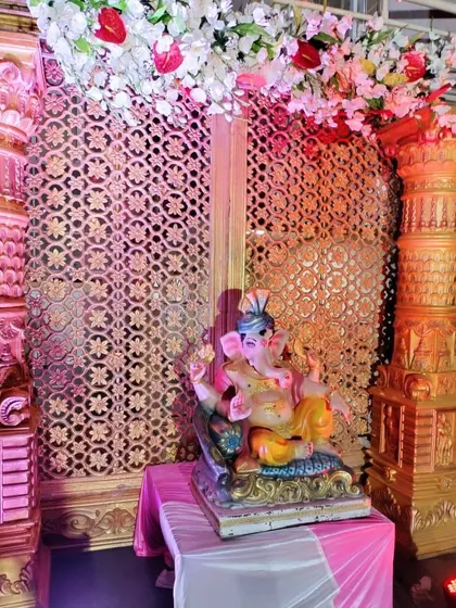 A Ganesha idol placed at the entrance of an event, decorated with flowers. I ensure even the small details contribute to the event's theme.