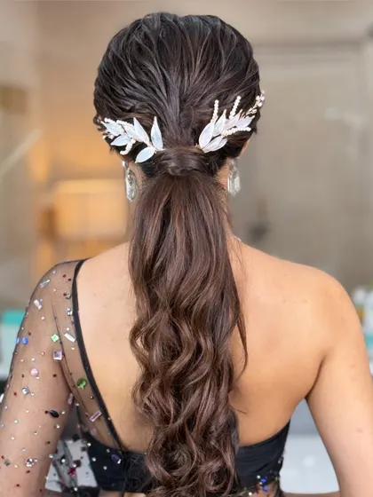 The dual accessories add a unique touch to this modern wet-look ponytail, creating a look that is both edgy and sophisticated.