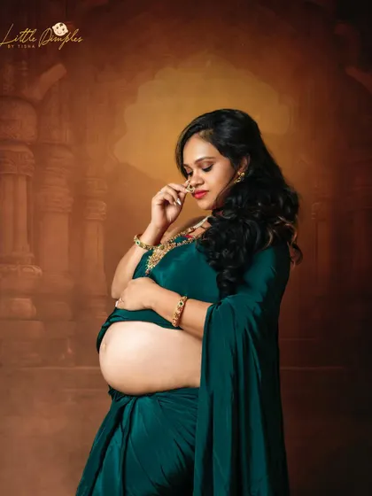 A close-up portrait showing the beautiful details of the jewelry and the gentle expression of this mom-to-be. The traditional nose ring adds a perfect touch.