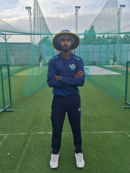 Our coach Chinna standing in front of our Astro Turf nets. We have 14 such wickets to ensure players can train on any surface and get ample practice time.
