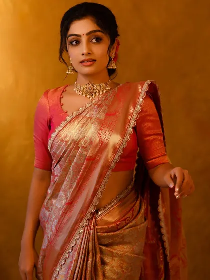 The beautiful sheen of this silk saree catches the light perfectly. A timeless piece for any celebration.