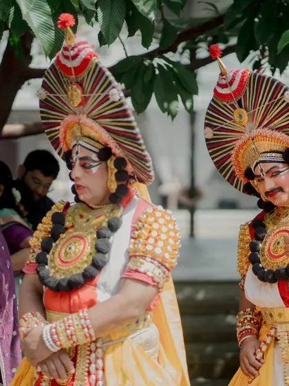 A close-up of the Yakshagana artists in their vibrant costumes and elaborate makeup. We source authentic performers to bring a high level of cultural artistry to your event.