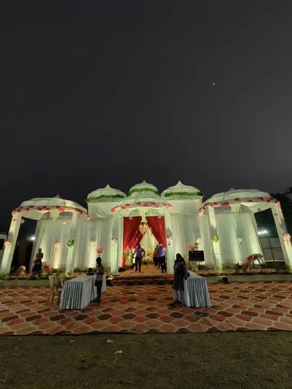 This night view shows how I use lighting to transform a space. The white dome-topped structures, inspired by traditional Indian architecture, are illuminated to create a magical and inviting atmosphere for an evening event.