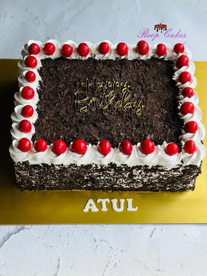 A classic, rich, and flavorful Black Forest sheet cake, generously topped with chocolate shavings and cherries.