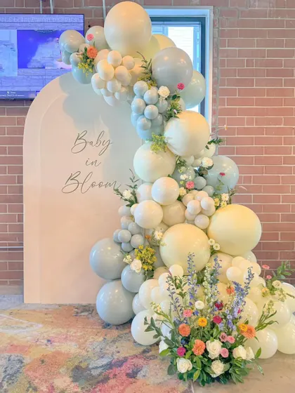 A "Baby in Bloom" setup with a pastel blue and yellow balloon garland. This shows how the theme can be customized with different color palettes.