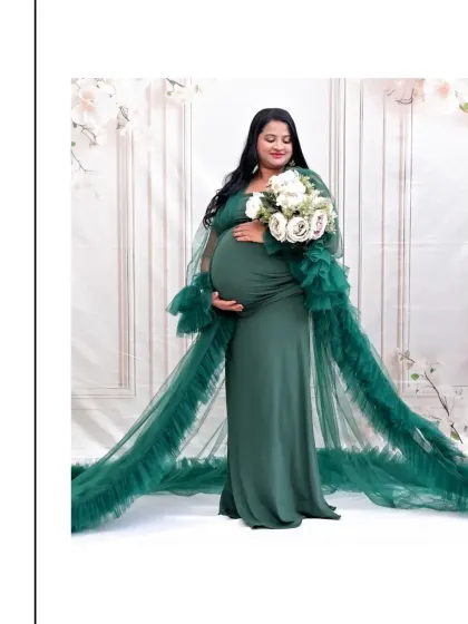 This is the essence of the maternity glow. I love capturing serene, powerful solo portraits like this one. The flowing emerald green tulle gown is part of my studio's collection, and it creates such a beautiful, dramatic effect against the soft, floral-inspired backdrop.