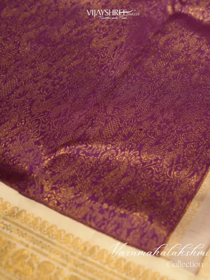 A royal purple and cream brocade Kanjivaram, a regal choice for the Varamahalakshmi season.