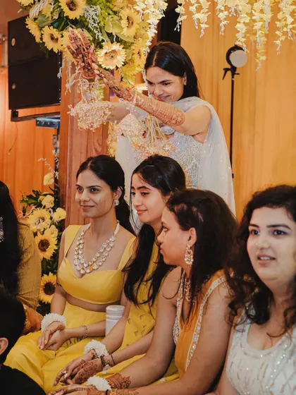 Another angle of the Kaleerein ceremony, showing the bride's friends fully engaged in this cherished tradition.