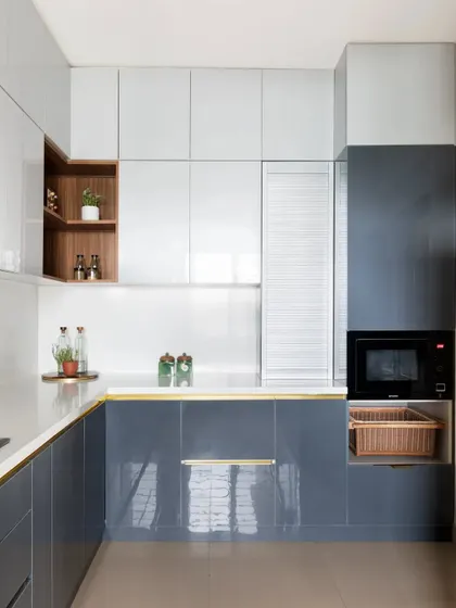 This view highlights the kitchen's practical design, with multiple drawers and a dedicated appliance garage with a shutter, ensuring ample storage and a clean look.