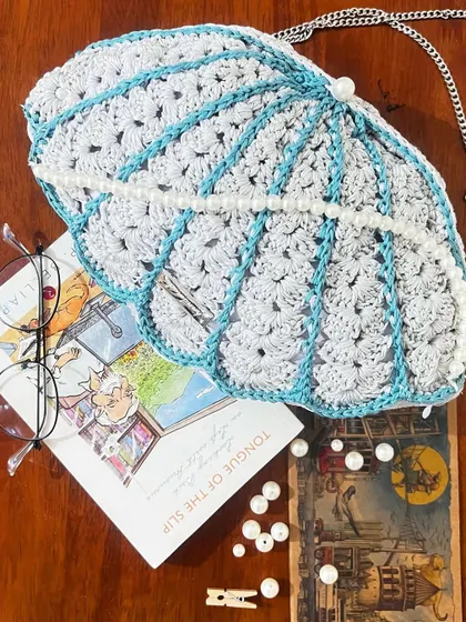 My Seashell Bag styled with a book and glasses. It’s more than a bag, it’s a piece of art.