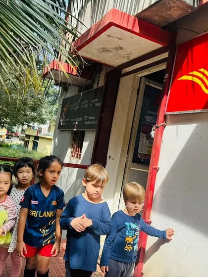 Our Pre-K class stands outside the local post office, ready to learn about how mail works in our community.